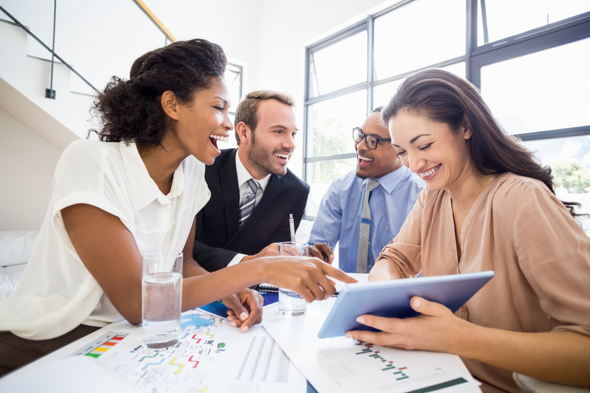 Businesspeople laughing in a meeting